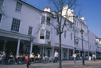 ENGLAND, Kent, Tunbridge Wells, The Pantiles. Cafe with outside seating and people sat at tables.