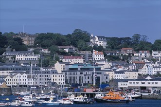 UNITED KINGDOM, Channel Islands, Guernsey, St Peter Port. Boats and quayside buldings.