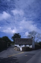 UNITED KINGDOM, Channel Islands, Guernsey, St Saviours. Small white cottage on corner of road