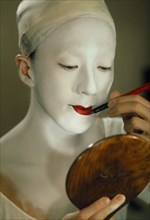 JAPAN, Traditional Theatre, Kabuki actor applying make up.  Female actors are banned as immoral and