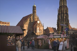 GERMANY, Bavaria, Nuremberg, The Christmas Market in Hauptmarkt with The Frauenkirche behind.