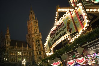 GERMANY, Bavaria, Munich, Gluhwein stall at the Christmas Market with the Rathaus behind.