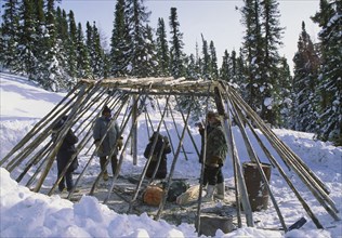 CANADA, Northern Quebec, "James Bay,", A group of people constructing a camp out of wood in the