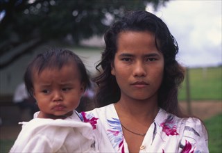 COLOMBIA, Casanare, A Llanera woman holding a child.