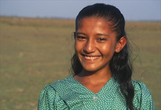 COLOMBIA, Casanare, A Llanera girl wearing a green top with white dots.