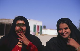 OMAN, Central, "Bedu women, including one wearing traditional face mask."