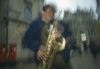 MUSIC, Brass, Saxophone, Travelling busker playing saxophone in Oxford.