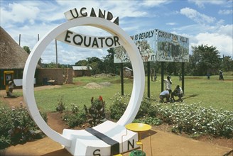 UGANDA, Equator, North and South sign. Corruption kills sign in the background.