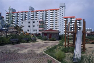 SOUTH KOREA, Sokcho, Large apartment block and childrens playground in east coast fishing port.