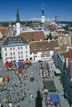 ESTONIA, Tallinn, View over busy Town Hall Square towards spires of St Olaf’s Church of the Holy