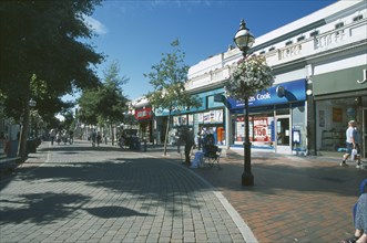 ENGLAND, East Sussex, Eastbourne, Pedestrian shopping area with line of shops and a row of small