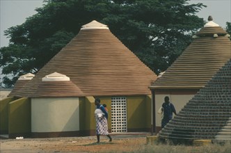 ANGOLA, Tradtional Homes, Women and child outside new village housing.