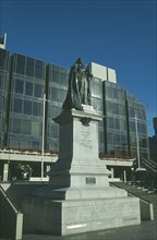 ENGLAND, Hampshire, Portsmouth, Guildhall Square. Statue of Queen Victoria with Council offices