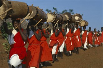 BURUNDI, Gishora, Line of traditional drummers or Tambourinaires dressed in red and white.