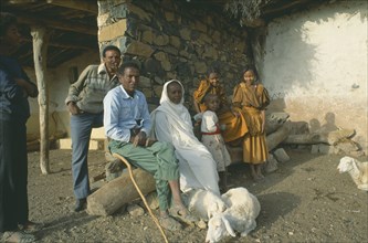 ERITREA, Seraye Province, Farming family outside home with sheep.