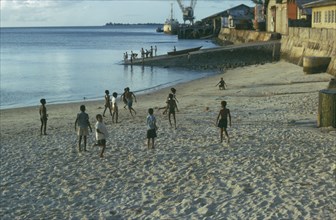 TANZANIA, Zanzibar Island, Boys playing football on the beach