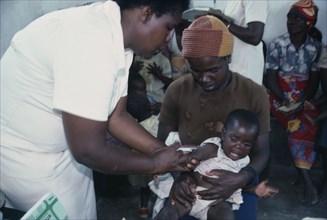 ZIMBABWE, Medical, Child receiving vaccination from female nurse.