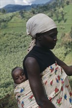 GHANA, Children, Carrying, Traditional Ghanaian way of holding baby in printed cotton sling on back
