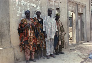 NIGERIA, Ede, Full length portrait of group of Yoruba men wearing traditional dress.