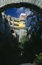 PORTUGAL, Estremadura, Sintra, Colourful Palacio Da Pena seen through an archway