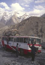 CHINA, Hunza, Karakorum, Bus negotiating a flooded river on the Karakorum highway on route to China