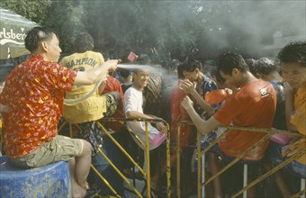 THAILAND, Bangkok, "Crowd having a water fight,  celebrating the Songkhran Festival. Thai New Year,
