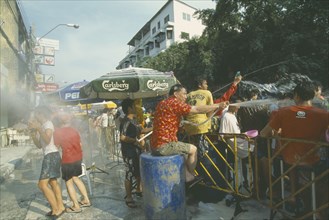 THAILAND, Bangkok, "Crowd having a water fight, celebrating the Songkhran Festival. Thai New Year,
