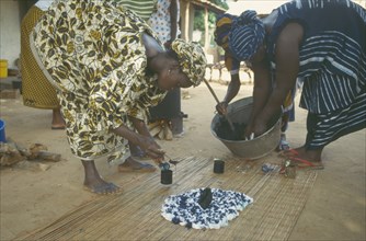 GAMBIA, People, Women working together to produce indigo tie dye fabric.