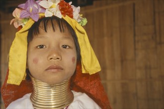 THAILAND, Chiang Rai, "Portrait of young Paduang girl, long neck, metal rings."