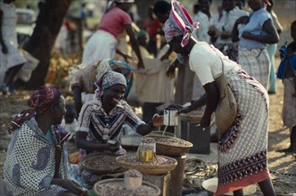 MOZAMBIQUE, Maxixe, Street market scene with women selling beans.