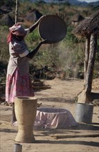 MOZAMBIQUE, Farming, Woman winnowing grain.