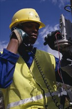 BOTSWANA, People, Work, Portrait of trainee electrical engineer working on terminal box.