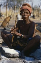BOTSWANA, Tsodilo Hills, Bushwoman making beads from ostrich egg shell.