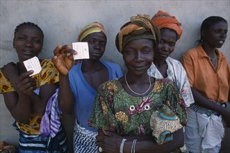 GUINEA, People, Women, Sierra Leonean refugees queuing for food rations at Kissidougou camp.