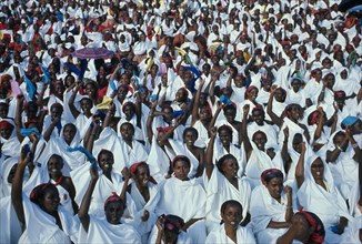 SOMALIA, Politics, Independence Day Parade. A mass of seated women with their arms raised in the