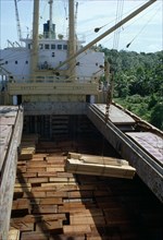 BRAZIL, Amazon, Logging, Timber being loaded onto ship for export.