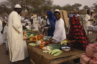 SUDAN, North Darfur, El Fasher, Fruit and vegetable stall at outside market with vendors and male
