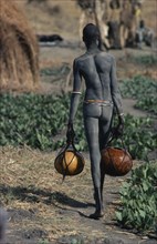 SUDAN, Tribal People, Dinka carrying gourds of water to irrigate crops.