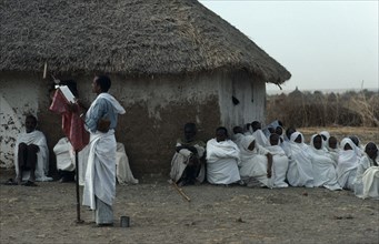 SUDAN, East, Religion, Coptic priest conducting open air othodox service in settlement for