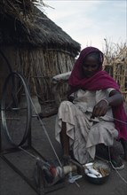 SUDAN, Refugees, Ethiopian refugee woman spinning wool in International Labour Organisation