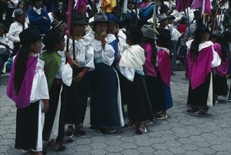 ECUADOR, Imbabura, Cotocachi, Line of girls dressed for Easter festivities.
