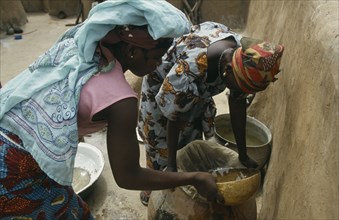 GHANA, Water, "Women filtering water to prevent guinea worm, a parasitic disease contracted when