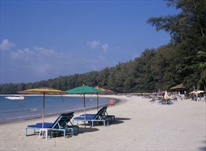 THAILAND, North Phuket, Naiyang Beach, "View along the sandy beach with sun loungers and colourful