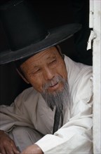 SOUTH KOREA, Seoul, Portrait of elderly Confucian Priest in traditional white robe and kat