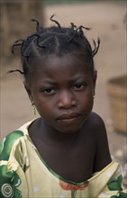 GHANA, People, Portrait of young girl from small village near Accra with her hair twisted into