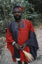 GHANA, Tribal People, Portrait of traditional priest and healer in village near Accra wearing black