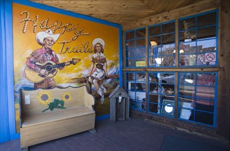 USA, New Mexico, Santa Fe, Happy Trails local arts and crafts shop and its front wall painted with