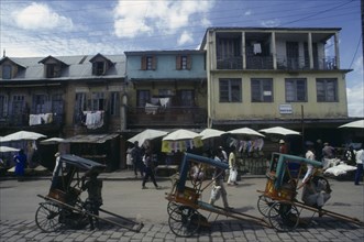 MADAGASCAR, Antananarivo, "Street scene with washing hanging from buildings above roadside stalls