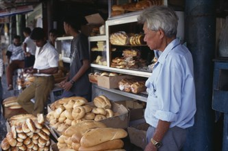 MAURITIUS, Port Louis, Vendor and customers at bread shop in old market in operation since 1828.