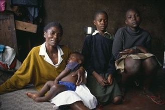 KENYA, Nairobi, "Korogocho slum area.  Margaret with two of her children and her fourteen year old